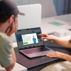 Two people looking at the Coolblue website on a laptop. The cookie banner is shown.